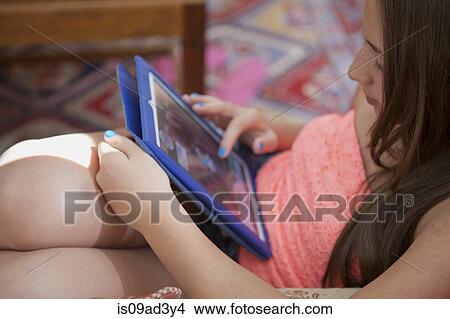 Girl using digital tablet View Large Photo Image Picture - Girl using digital tablet. Fotosearch