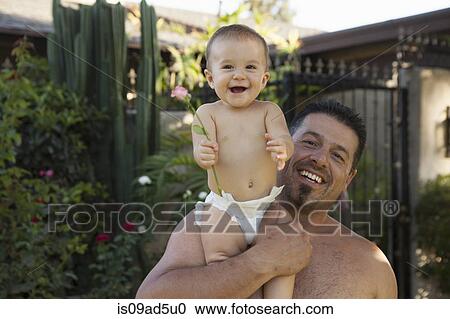 Stock Image - Grandfather holding baby granddaughter. Fotosearch
