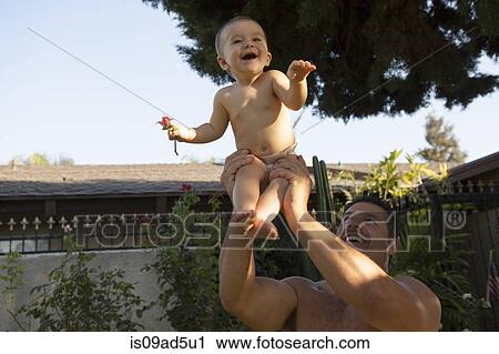 Stock Image - Grandfather holding baby granddaughter. Fotosearch