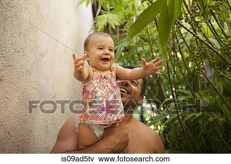 Grandfather holding baby granddaughter View Large Photo Image Stock Photo - Grandfather holding baby granddaughter. Fotosearch