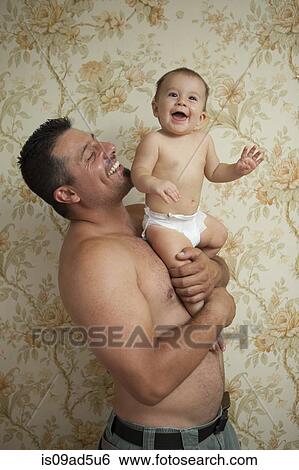 Stock Photograph - Grandfather holding baby granddaughter. Fotosearch