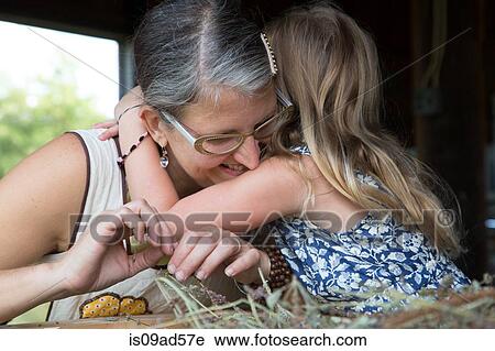 Stock Image - Mother and daughter hugging. Fotosearch