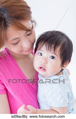Mother looking down at baby in arms View Large Photo Image Stock Image - Mother looking down at baby in arms. Fotosearch