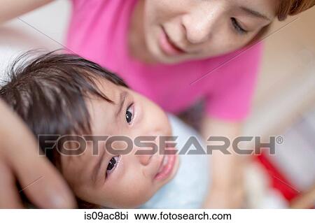 Mother pacifying crying baby View Large Photo Image Stock Image - Mother pacifying crying baby. Fotosearch