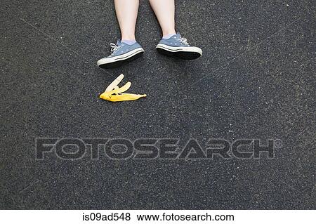 Pair of legs and banana skin on tarmac View Large Photo Image Stock Photo - Pair of legs and banana skin on tarmac. Fotosearch
