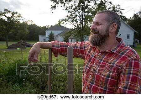 Stock Photograph - Portrait of mature man on herb farm. Fotosearch