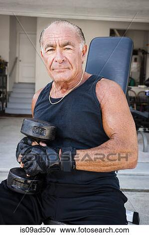 Portrait of muscular senior man holding dumb bells View Large Photo Image Stock Photo - Portrait of muscular senior man holding dumb bells. Fotosearch