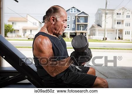Portrait of muscular senior man lifting dumb bells View Large Photo Image Stock Photo - Portrait of muscular senior man lifting dumb bells. Fotosearch
