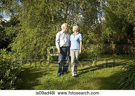 Stock Image - Portrait of senior couple in garden. Fotosearch