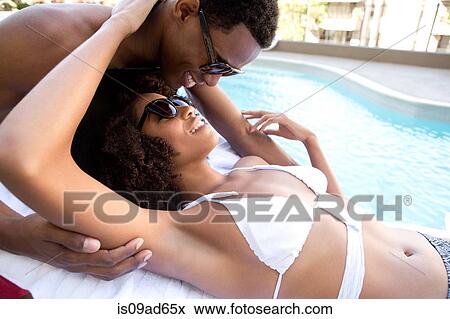 Portrait of young couple at poolside View Large Photo Image Stock Photo - Portrait of young couple at poolside. Fotosearch