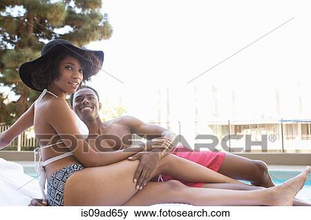 Portrait of young couple at poolside View Large Photo Image Stock Photo - Portrait of young couple at poolside. Fotosearch