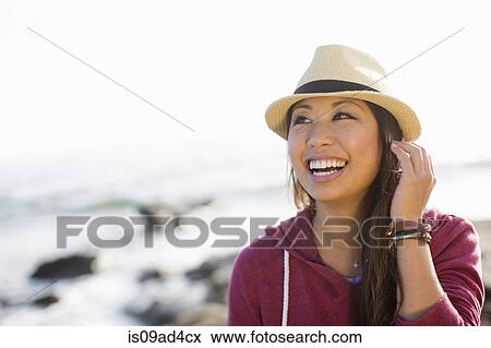 Stock Photo - Portrait of young woman at coast, San Diego, California, USA. Fotosearch