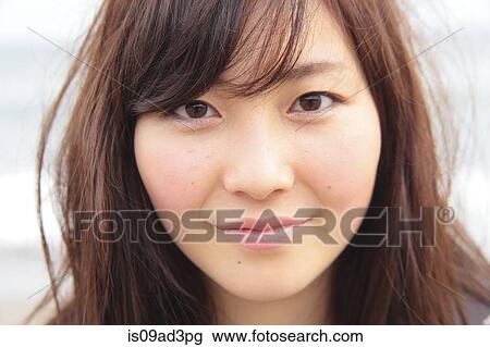 Portrait of young woman, close up View Large Photo Image Stock Image - Portrait of young woman, close up. Fotosearch