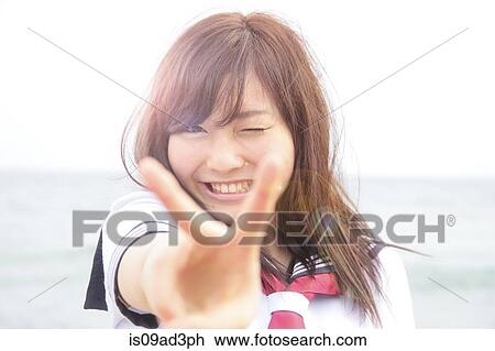 Portrait of young woman doing peace sign View Large Photo Image Stock Image - Portrait of young woman doing peace sign. Fotosearch