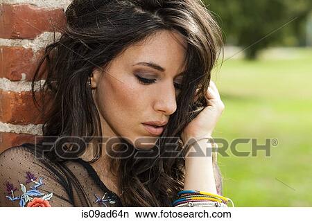 Picture - Portrait of young woman looking down. Fotosearch
