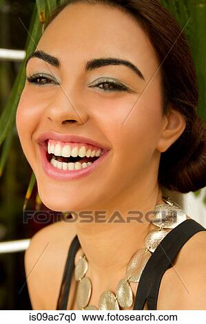 Portrait of young woman, smiling wearing circle necklace View Large Photo Image Stock Image - Portrait of young woman, smiling wearing circle necklace. Fotosearch