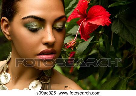 Portrait of young woman with red orchid and foliage View Large Photo Image Stock Photography - Portrait of young woman with red orchid and foliage. Fotosearch