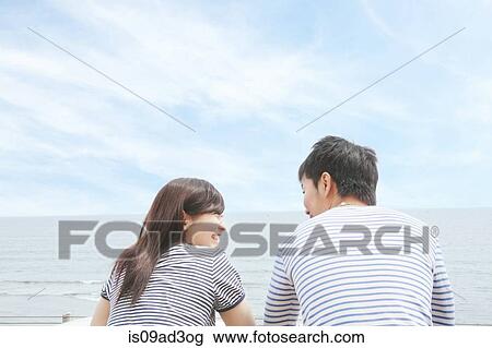 Rear view of couple at coast, face to face and laughing View Large Photo Image Stock Image - Rear view of couple at coast, face to face and laughing. Fotosearch