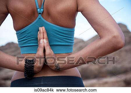 Rear view of woman with hands together behind her back View Large Photo Image Stock Image - Rear view of woman with hands together behind her back. Fotosearch