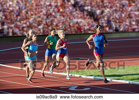 Runners racing on track View Large Photo Image Stock Photo - Runners racing on track. Fotosearch