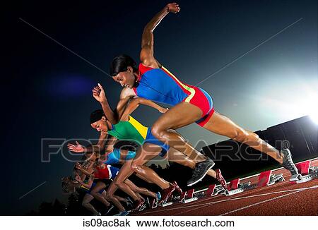 Stock Image - Runners starting race. Fotosearch