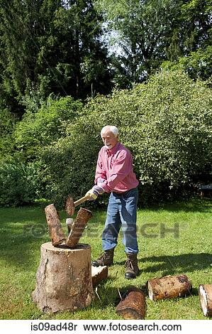 Senior man chopping logs in garden View Large Photo Image Stock Photography - Senior man chopping logs in garden. Fotosearch