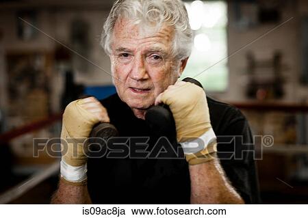 Senior man wearing gloves, lifting weights View Large Photo Image Stock Image - Senior man wearing gloves, lifting weights. Fotosearch