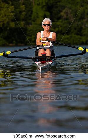 Senior woman rowing in rowing boat View Large Photo Image Picture - Senior woman rowing in rowing boat. Fotosearch