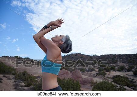 Side view of woman doing yoga at Vazquez Rocks, LA View Large Photo Image Stock Image - Side view of woman doing yoga at Vazquez Rocks, LA. Fotosearch