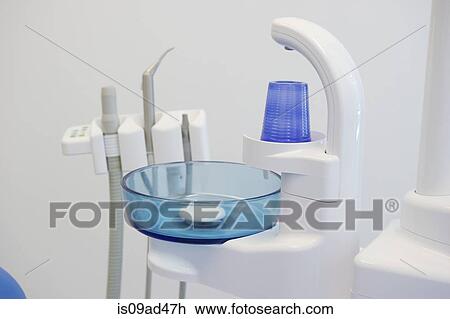 Stock Image - Sink and plastic cup in dental office. Fotosearch