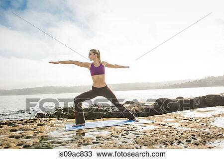 Woman doing yoga at coast View Large Photo Image Stock Image - Woman doing yoga at coast. Fotosearch