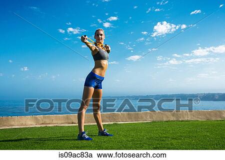Woman doing yoga at coast View Large Photo Image Stock Image - Woman doing yoga at coast. Fotosearch