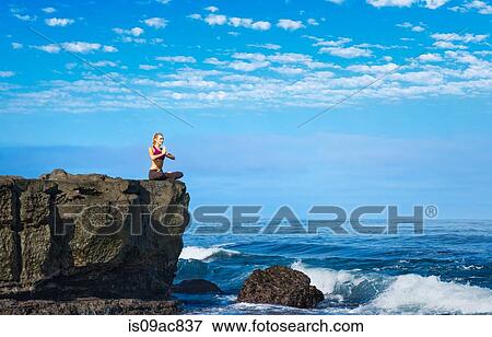 Woman doing yoga at coast View Large Photo Image Stock Photo - Woman doing yoga at coast. Fotosearch
