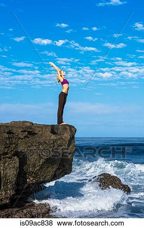 Woman doing yoga at coast View Large Photo Image Stock Photo - Woman doing yoga at coast. Fotosearch