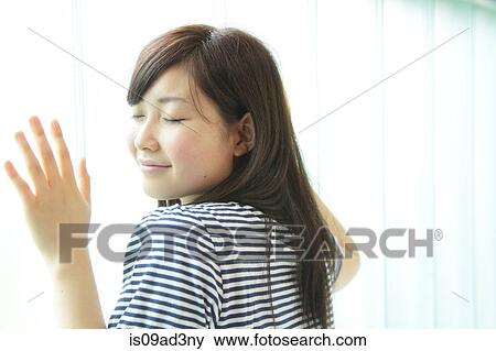 Woman leaning against window with eyes closed View Large Photo Image Stock Photo - Woman leaning against window with eyes closed. Fotosearch