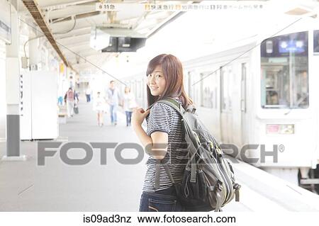Stock Photo - Woman on platform at train station. Fotosearch