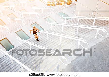 Woman running up stairs View Large Photo Image Stock Image - Woman running up stairs. Fotosearch