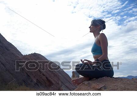 Woman sitting cross legged at Vazquez Rocks, meditating View Large Photo Image Stock Photography - Woman sitting cross legged at Vazquez Rocks, meditating. Fotosearch
