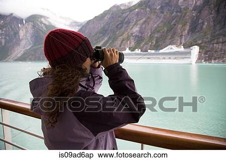 Woman using binoculars on cruise ship, Ketchikan, Alaska, USA View Large Photo Image Stock Photography - Woman using binoculars on cruise ship, Ketchikan, Alaska, USA. Fotosearch