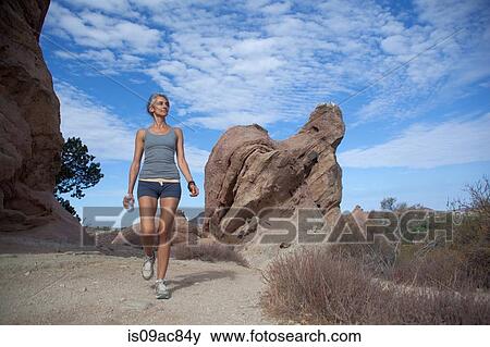 Stock Photo - Woman walking through Vazquez Rocks. Fotosearch