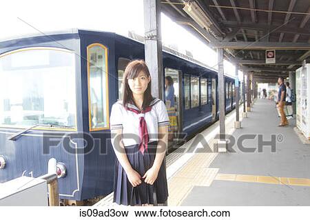 Woman wearing school uniform on railway platform at train station View Large Photo Image Stock Photo - Woman wearing school uniform on railway platform at train station. Fotosearch