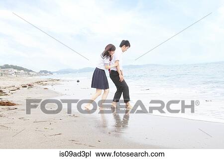Young couple fooling around on beach View Large Photo Image Stock Image - Young couple fooling around on beach. Fotosearch