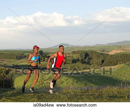 Stock Photo - Young couple jogging in landscape, Othello, Washington, USA. Fotosearch