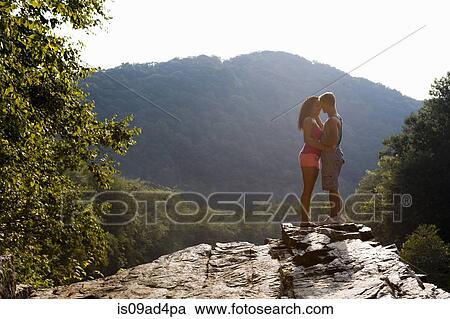 Young couple kissing on rock ledge, Hamburg, Pennsylvania, USA View Large Photo Image Stock Image - Young couple kissing on rock ledge, Hamburg, Pennsylvania, USA. Fotosearch