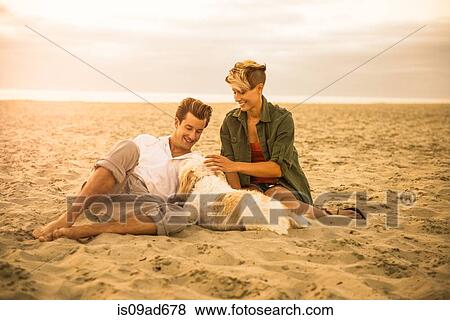 Young couple on Mission Beach with dog, San Diego, California, USA View Large Photo Image Stock Photo - Young couple on Mission Beach with dog, San Diego, California, USA. Fotosearch