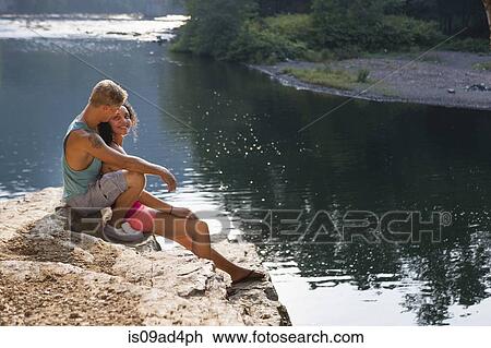 Young couple sitting on rock ledge, Hamburg, Pennsylvania, USA View Large Photo Image Stock Image - Young couple sitting on rock ledge, Hamburg, Pennsylvania, USA. Fotosearch