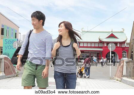 Young couple walking through town View Large Photo Image Picture - Young couple walking through town. Fotosearch