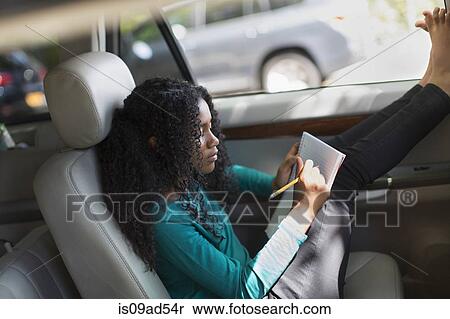 Young girl in car doing homework View Large Photo Image Stock Photography - Young girl in car doing homework. Fotosearch
