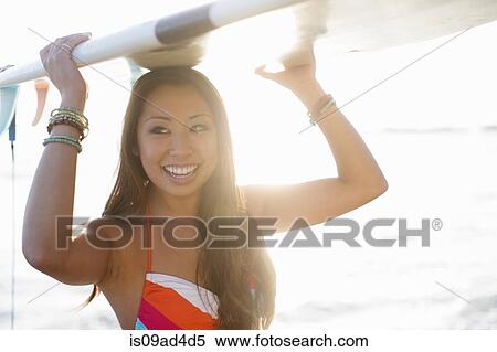Young woman carrying surfboard, San Diego, California, USA View Large Photo Image Stock Photography - Young woman carrying surfboard, San Diego, California, USA. Fotosearch
