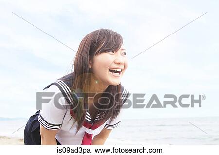Young woman leaning forwards laughing View Large Photo Image Stock Image - Young woman leaning forwards laughing. Fotosearch